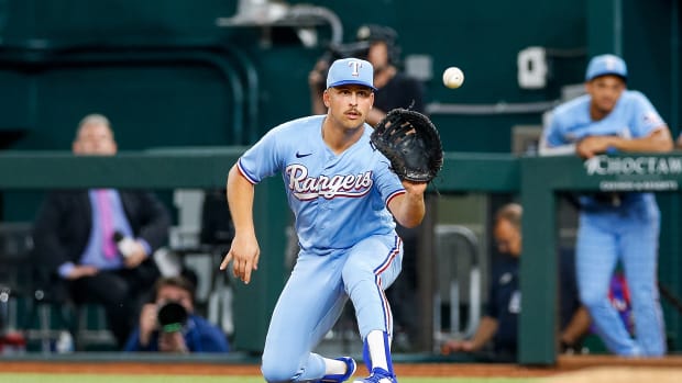 Apr 2, 2023; Arlington, Texas, USA; Texas Rangers first baseman Nathaniel Lowe (30) fields a throw during the eighth inning against the Philadelphia Phillies at Globe Life Field. Mandatory Credit: Andrew Dieb-USA TODAY Sports